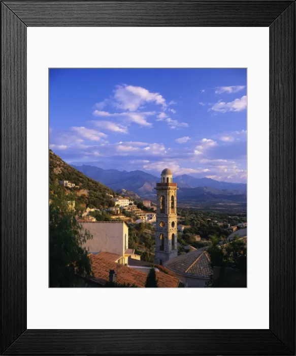 Framed Print : Evening view across rooftops and church tower to mountains, Lumio, near Calvi Framed Print : Evening view across rooftops and church tower to mountains, Lumio, near Calvi