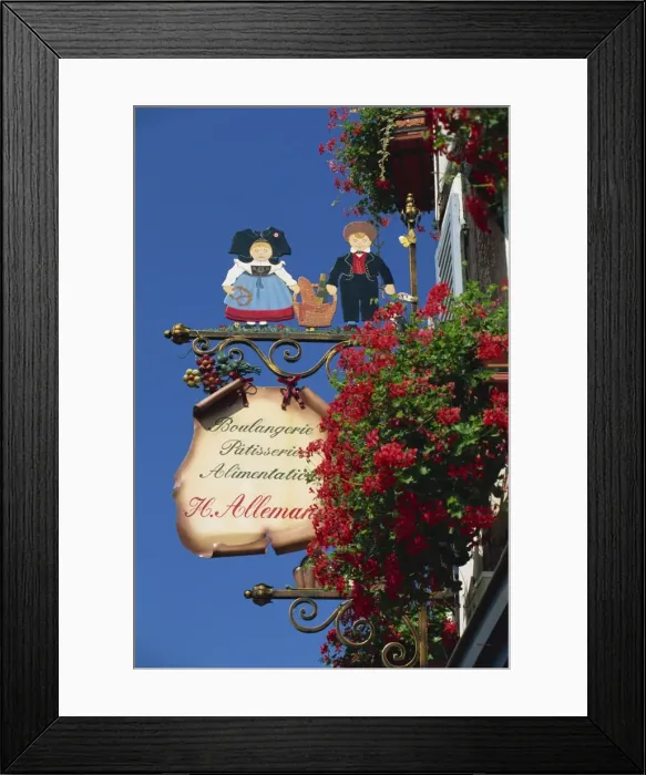 Framed Print : Sign outside traditional patisserie, red flowers prominent, Eguisheim, Haut-Rhin