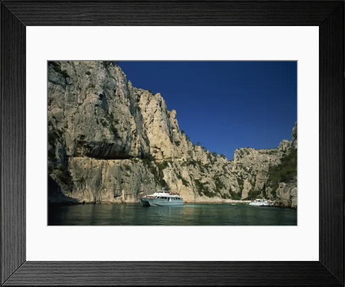 Framed Print : Boat dwarfed by cliffs of the Calanque d En-Vau, near Cassis, Bouches-du-Rhone Framed Print : Boat dwarfed by cliffs of the Calanque d En-Vau, near Cassis, Bouches-du-Rhone