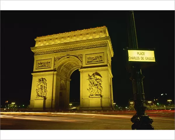 Place Charles de Gaulle street sign and the Arc de Triomphe illuminated at night