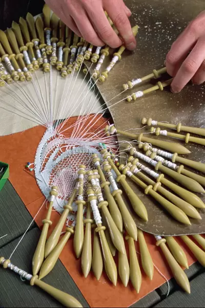 Close-up of hands and bobbins for lace making at Le Puy in the Auvergne, France, Europe