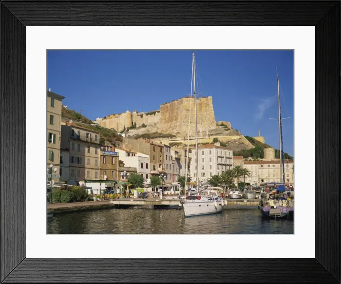 Framed Print : Yacht moored in harbour, with the citadel behind, Bonifacio, Corsica, France Framed Print : Yacht moored in harbour, with the citadel behind, Bonifacio, Corsica, France