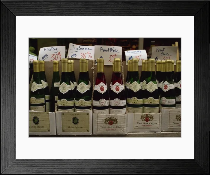 Framed Print : Close-up of bottles of white and rose wine on sale, France, Europe Framed Print : Close-up of bottles of white and rose wine on sale, France, Europe