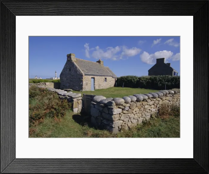 Framed Print : Ancient house with Creac h lighthouse behind on Ouessant Island, Brittany Framed Print : Ancient house with Creac h lighthouse behind on Ouessant Island, Brittany