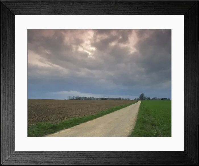 Framed Print : Overcast sky and rural road through fields in agricultural landscape near Entrepagny Framed Print : Overcast sky and rural road through fields in agricultural landscape near Entrepagny