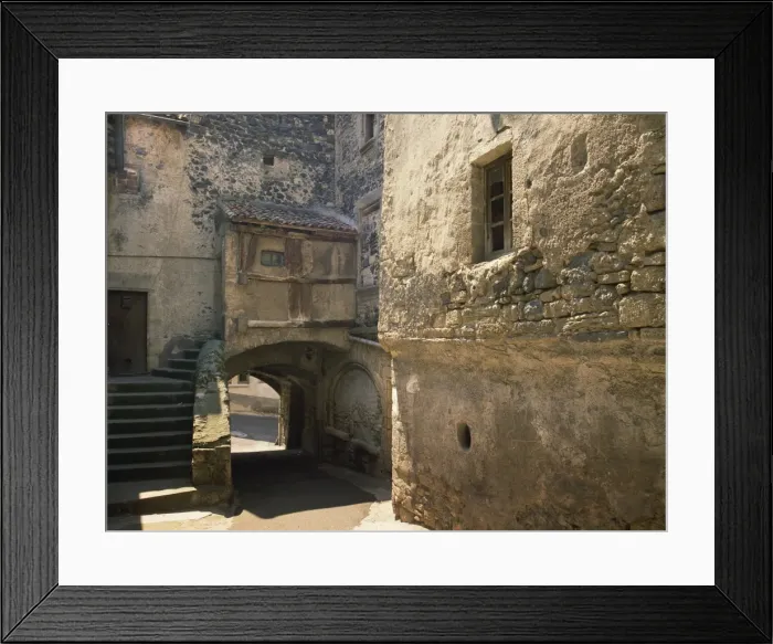 Framed Print : Exterior of village houses and arch on a street in St. Saturnin in the Auvergne Framed Print : Exterior of village houses and arch on a street in St. Saturnin in the Auvergne
