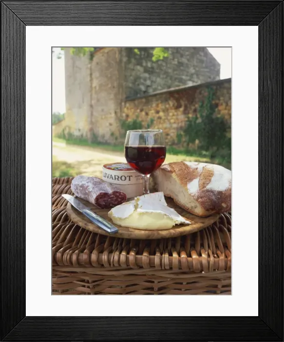 Framed Print : Still life of bread, glass of red wine, cheese and sausage, picnic meal on top of a wicker basket Framed Print : Still life of bread, glass of red wine, cheese and sausage, picnic meal on top of a wicker basket