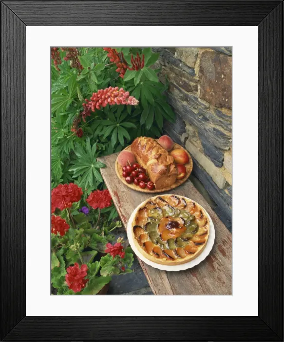 Framed Print : High angle view of still life of brioche and fruit tart patisserie outside in a garden with geraniums and lupins Framed Print : High angle view of still life of brioche and fruit tart patisserie outside in a garden with geraniums and lupins