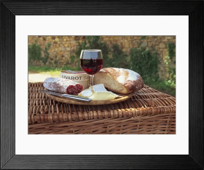 Framed Print : Still life of bread, cheese, glass of red wine and sausage, picnic lunch on top of a wicker basket Framed Print : Still life of bread, cheese, glass of red wine and sausage, picnic lunch on top of a wicker basket