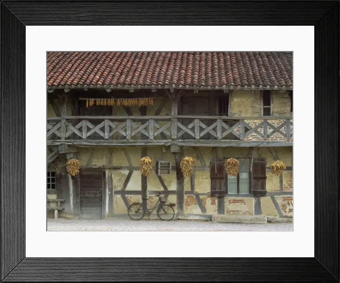 Framed Print : Timbered house with verandah, with maize bundles hanging to dry, and a bicycle parked outside in Ferme de la Foret near Bresse, Ain, Rhone Alpes Framed Print : Timbered house with verandah, with maize bundles hanging to dry, and a bicycle parked outside in Ferme de la Foret near Bresse, Ain, Rhone Alpes