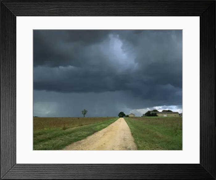 Framed Print : Straight rural dirt road through farmland near Le Mans, overcast stormy sky Framed Print : Straight rural dirt road through farmland near Le Mans, overcast stormy sky