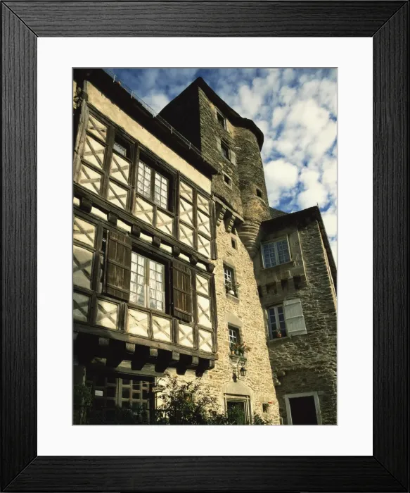 Framed Print : Exterior of stone house with wooden windows and turret in the village of Segur le Chateau Framed Print : Exterior of stone house with wooden windows and turret in the village of Segur le Chateau
