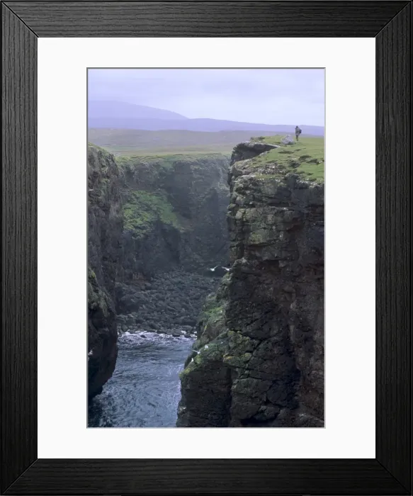 Framed Print : Eshaness basalt cliffs, Calders Geo, ancient volcanic crater, coast deeply eroded with caves Framed Print : Eshaness basalt cliffs, Calders Geo, ancient volcanic crater, coast deeply eroded with caves