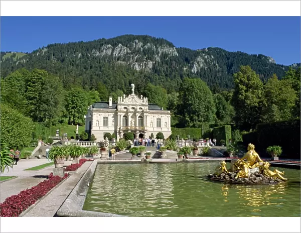 Gilded statues and pool in the gardens in front of Linderhof Castle