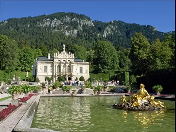 Gilded statues and pool in the gardens in front of Linderhof Castle