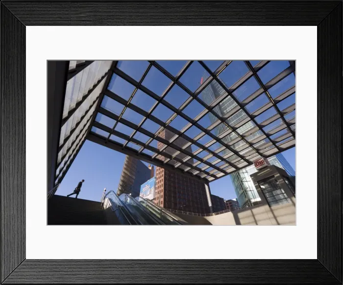 Framed Print : Man walking past subway station in new urban development Framed Print : Man walking past subway station in new urban development