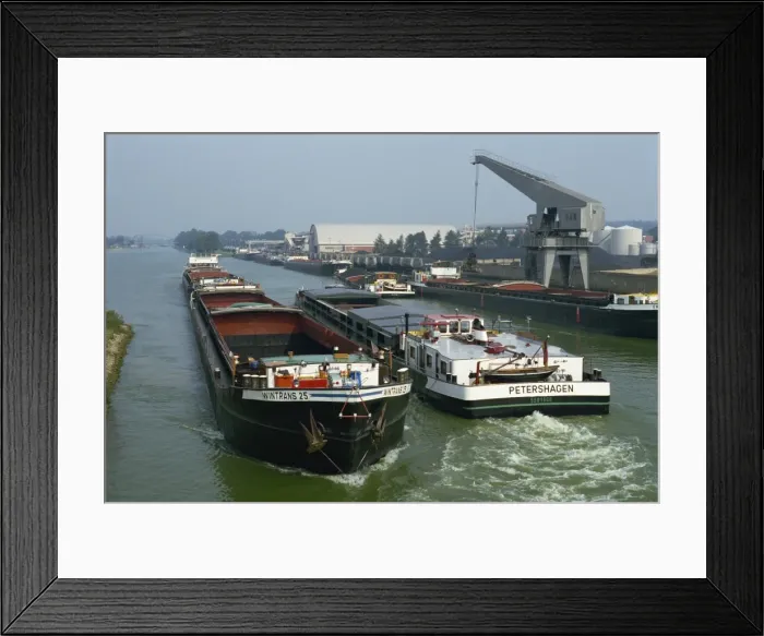 Framed Print : Large barges pass on busy canal near the Netherlands border Framed Print : Large barges pass on busy canal near the Netherlands border
