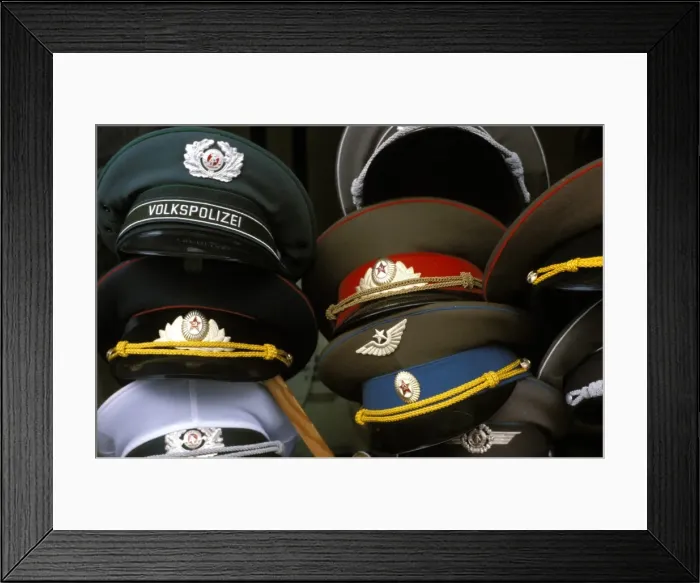 Framed Print : A pile of Communist era army and police hats for sale as souvenirs Framed Print : A pile of Communist era army and police hats for sale as souvenirs