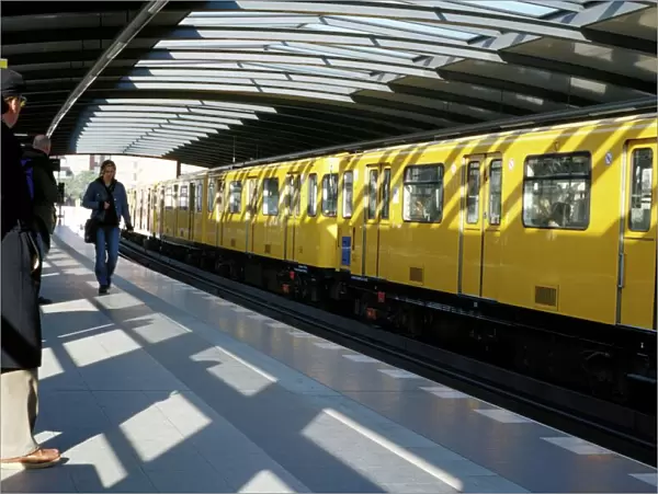 Passengers on the platform and a yellow train