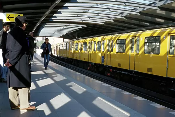 Passengers on the platform and a yellow train