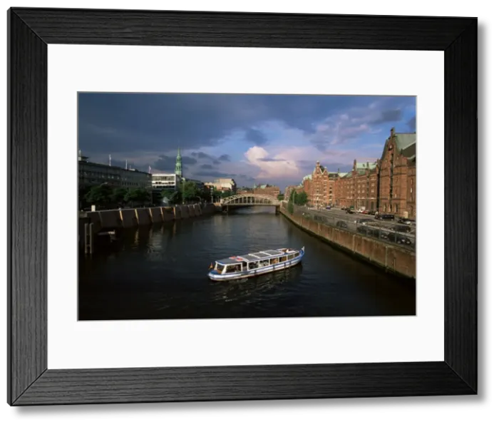 Framed Print : Excursion boat on canal in the Speicherstadt Framed Print : Excursion boat on canal in the Speicherstadt