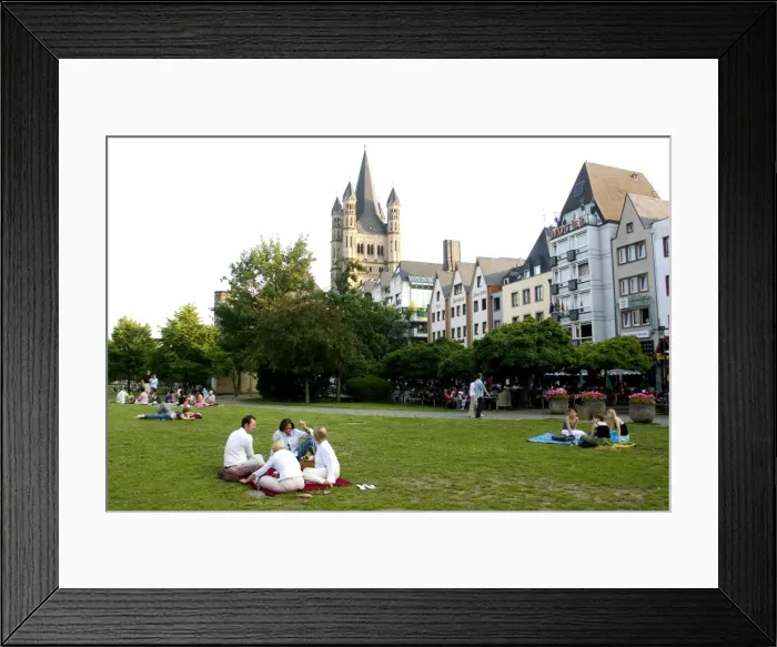 Framed Print : People sitting in a park in the old town with St Framed Print : People sitting in a park in the old town with St