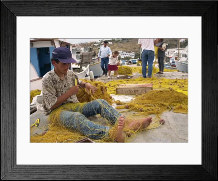 Framed Print : Fisherman using hands and feet to repair fishing net on Mykonos Framed Print : Fisherman using hands and feet to repair fishing net on Mykonos