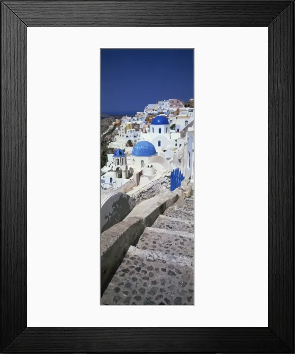 Framed Print : Village of Oia with blue-domed churches and whitewashed buildings Framed Print : Village of Oia with blue-domed churches and whitewashed buildings