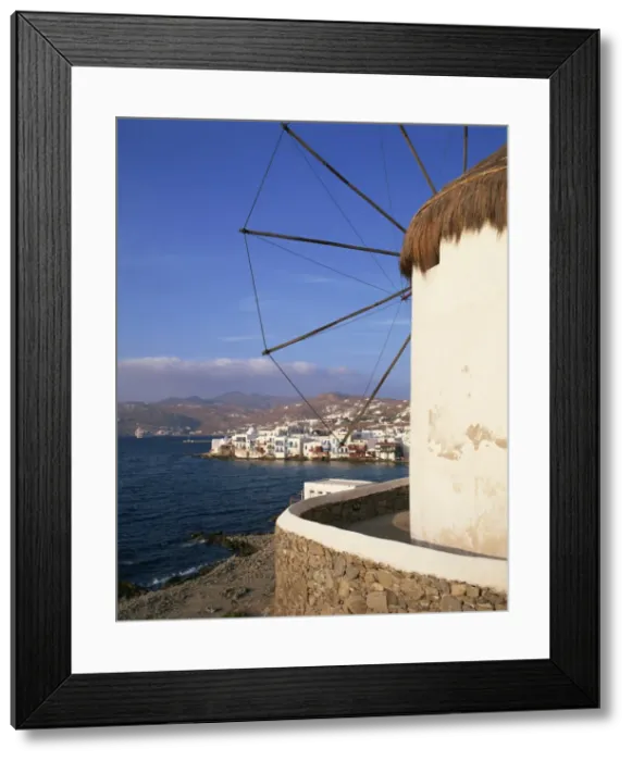 Framed Print : Thatched windmill with town and hills in the background on Mykonos Framed Print : Thatched windmill with town and hills in the background on Mykonos