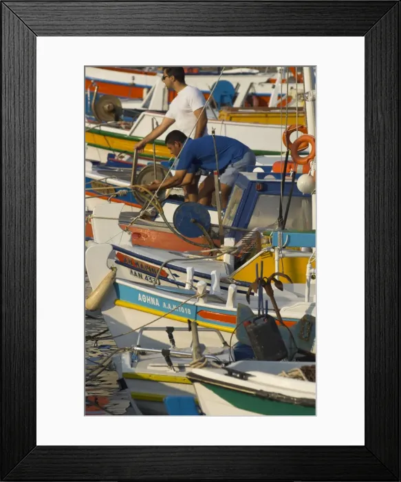 Framed Print : Close up of row of fishing boats in harbour with two men on board Framed Print : Close up of row of fishing boats in harbour with two men on board