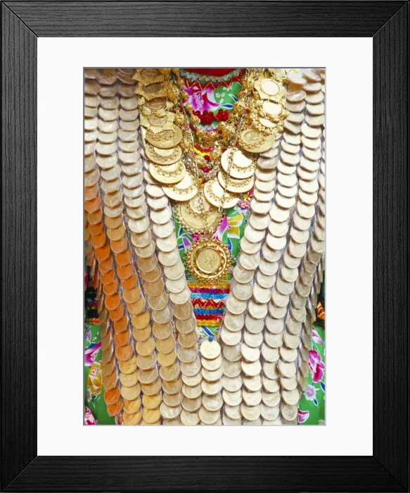 Framed Print : Close-up of a girls dress decorated with old gold coins