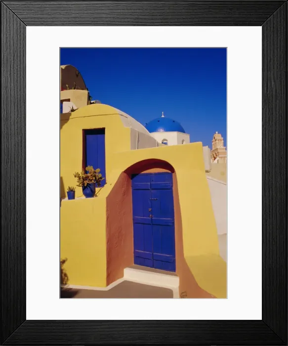 Framed Print : Blue and yellow traditional house with churches in the background Framed Print : Blue and yellow traditional house with churches in the background