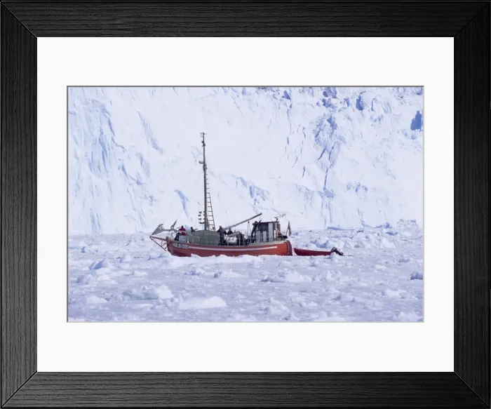 Framed Print : Red wooden boat crossing the ice in front of the Eqi Glacier Framed Print : Red wooden boat crossing the ice in front of the Eqi Glacier