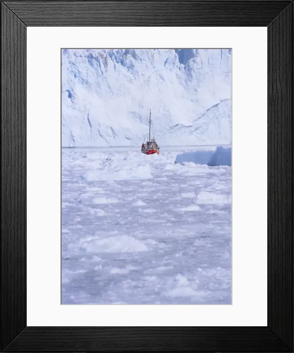 Framed Print : Red wooden boat crossing the ice in front of the Eqi Glacier Framed Print : Red wooden boat crossing the ice in front of the Eqi Glacier