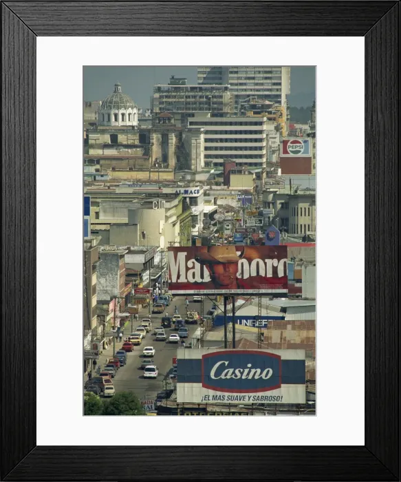 Framed Print : View down 7 Avenida with advertising signs and buildings Framed Print : View down 7 Avenida with advertising signs and buildings