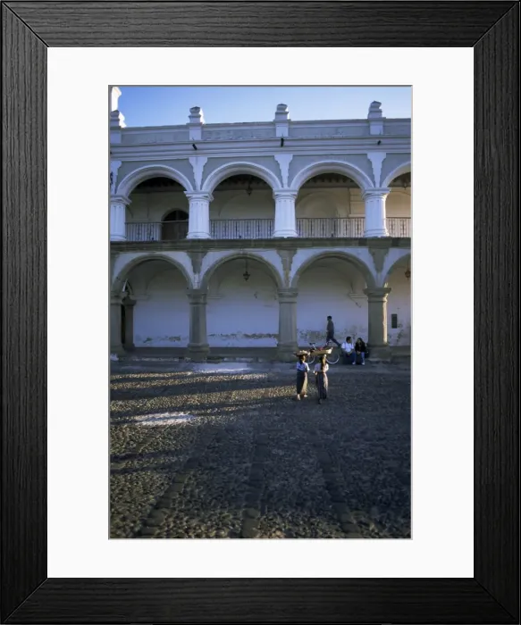 Framed Print : Girls in local clothing carry crafts on heads Framed Print : Girls in local clothing carry crafts on heads