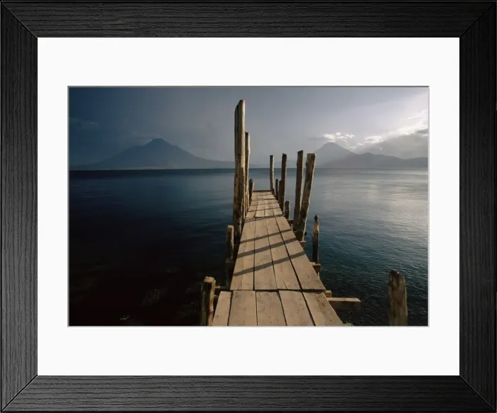 Framed Print : Wooden jetty and volcanoes in the distance Framed Print : Wooden jetty and volcanoes in the distance