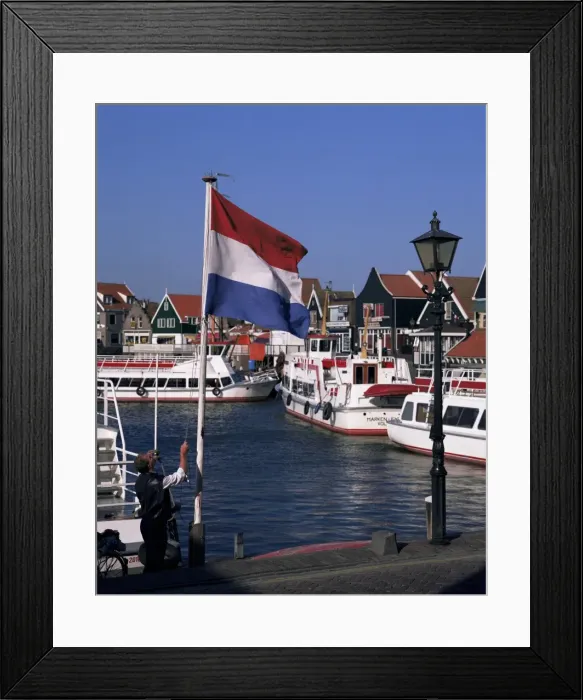 Framed Print : Raising the Dutch flag by the harbour Framed Print : Raising the Dutch flag by the harbour