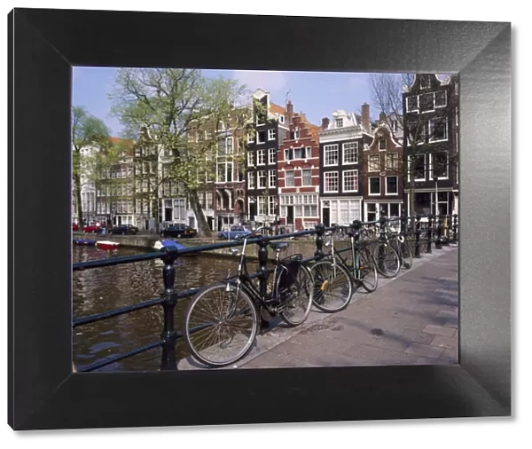 Bicycles on a bridge across the canal at Herengracht in Amsterdam