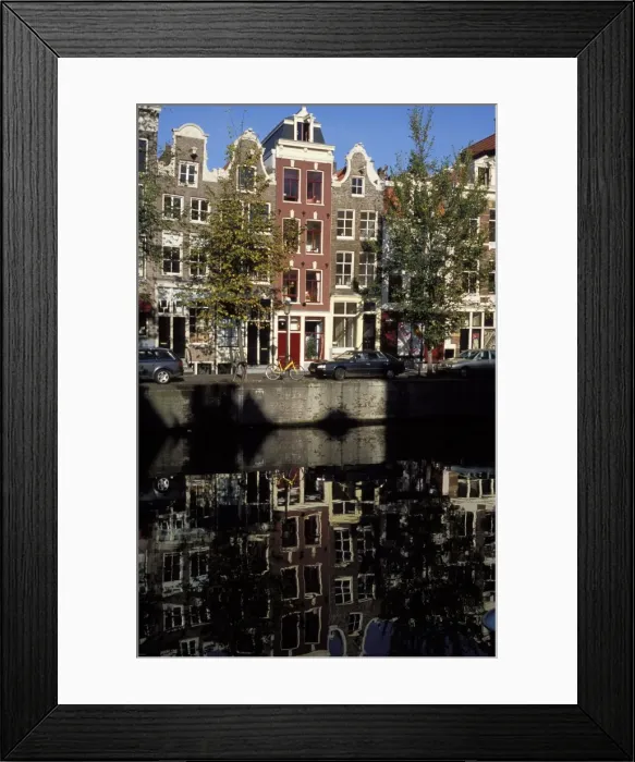 Framed Print : Tall traditional style houses reflected in the water of a canal Framed Print : Tall traditional style houses reflected in the water of a canal