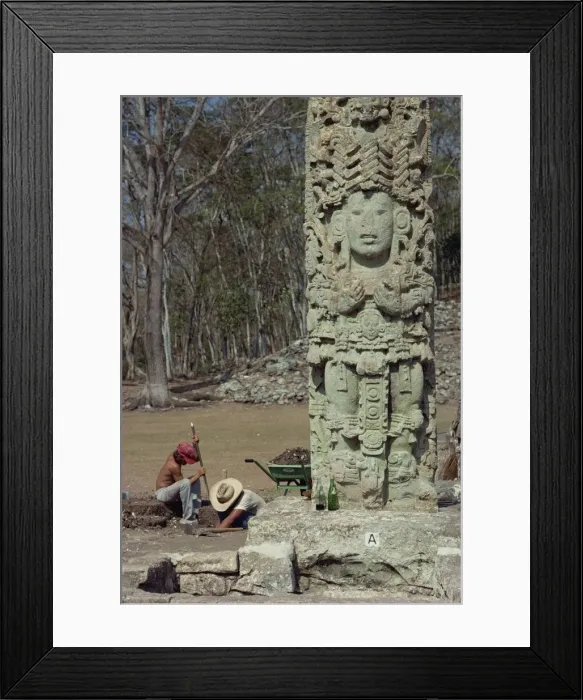 Framed Print : Two men excavating beside the Main Court Stela in Framed Print : Two men excavating beside the Main Court Stela in