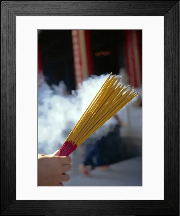 Framed Print : Hand holding smoking incense sticks in Hong Kong Framed Print : Hand holding smoking incense sticks in Hong Kong