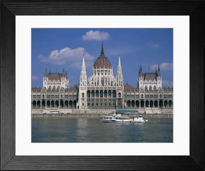 Framed Print : Tourists on a boat on the River Danube pass the Parliament Framed Print : Tourists on a boat on the River Danube pass the Parliament