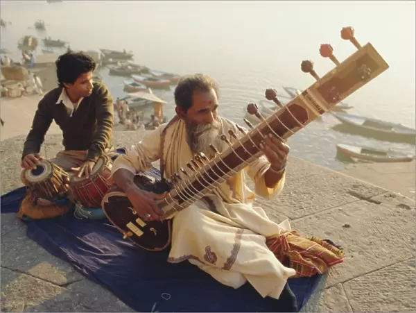 Musicians playing the Sitar and Tabla on the banks