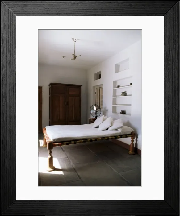 Framed Print : Bedroom with traditional low slung bed or charpoy in a home in Amber Framed Print : Bedroom with traditional low slung bed or charpoy in a home in Amber