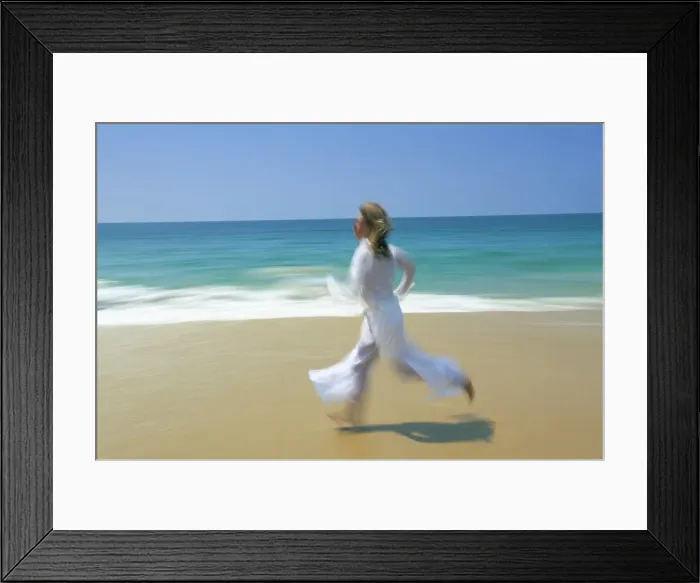 Framed Print : Woman running along beach Framed Print : Woman running along beach