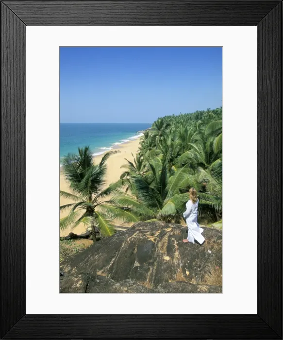 Framed Print : Woman looking over coconut palms to the beach Framed Print : Woman looking over coconut palms to the beach