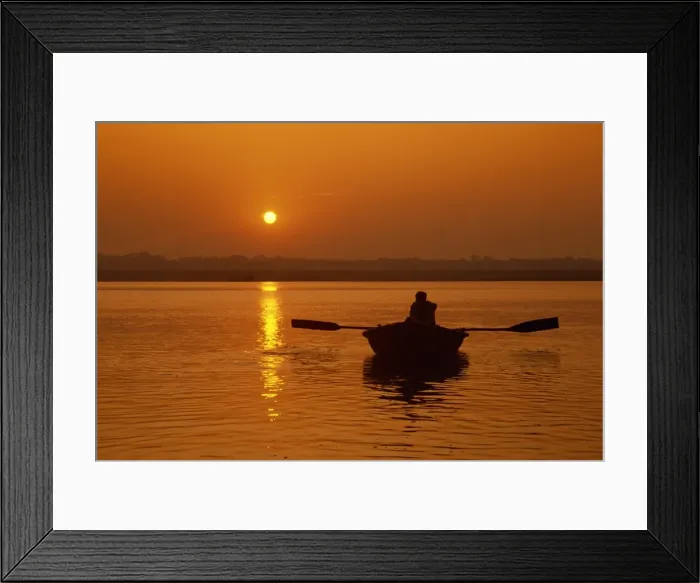 Framed Print : Figure in rowing boat silhouetted at sunset Framed Print : Figure in rowing boat silhouetted at sunset