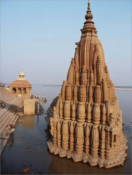 Partially submerged tilted Shiva temple below the ghats