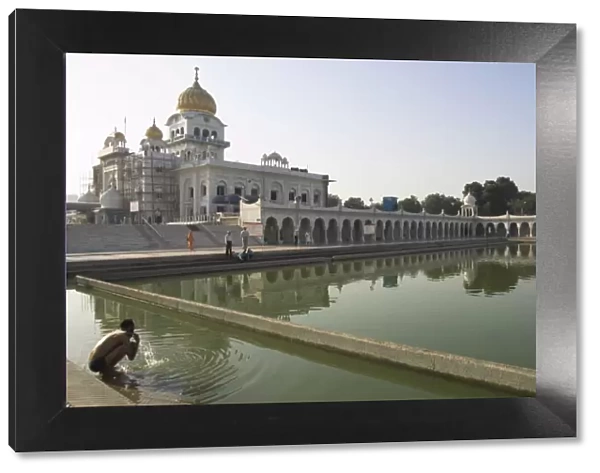 Sikh pilgrim bathing in the pool of the Gurudwara Bangla Sahib temple